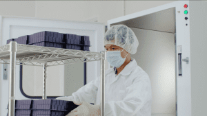 a staff wearing mask working in a clean room