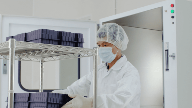 a staff wearing mask working in a clean room